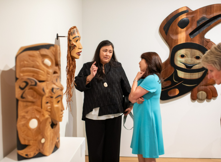 Arlene Ness speaks to an exhibition attendee at the opening. 