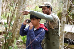 A student points something out to one of his peers during the field school.