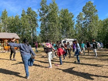 The field school class stretches before starting their learning.